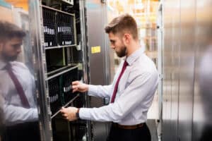 technician providing it service and inspecting server