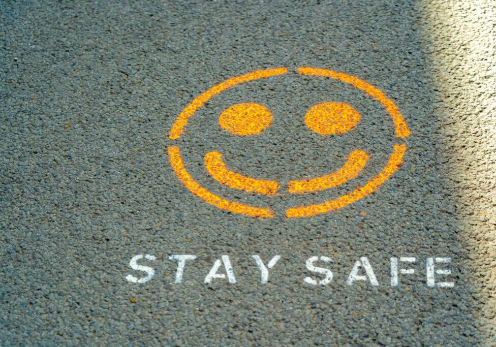 image of a yellow smiley face with white text saying stay safe on the road